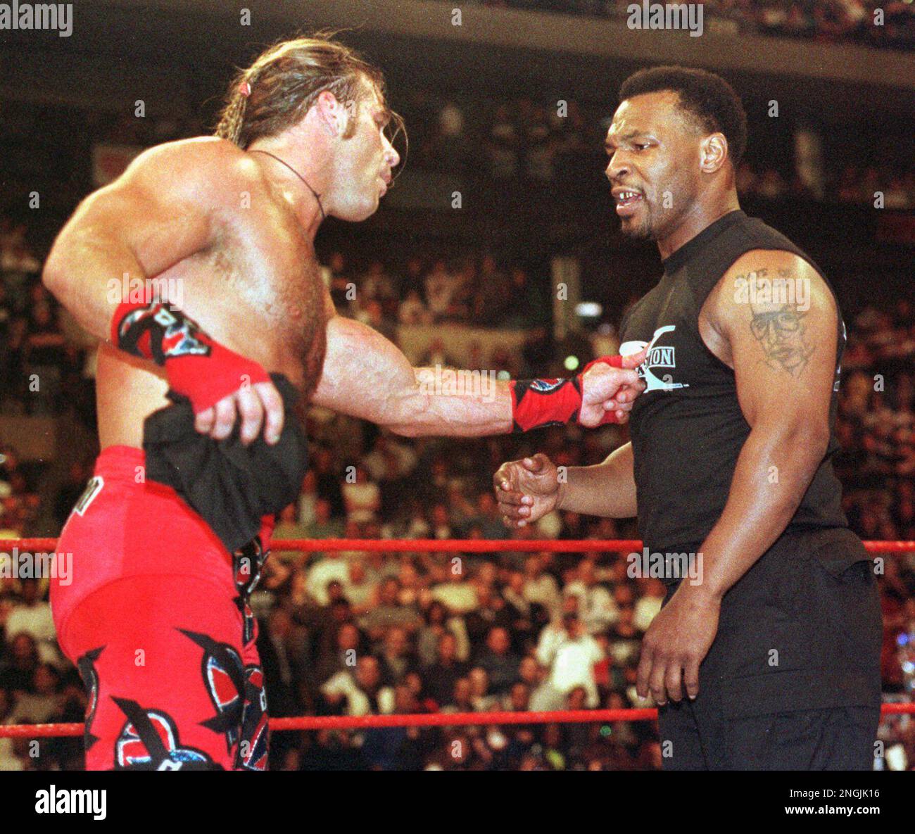 Former Heavyweight Champion Boxer Mike Tyson, right, gets a finger in