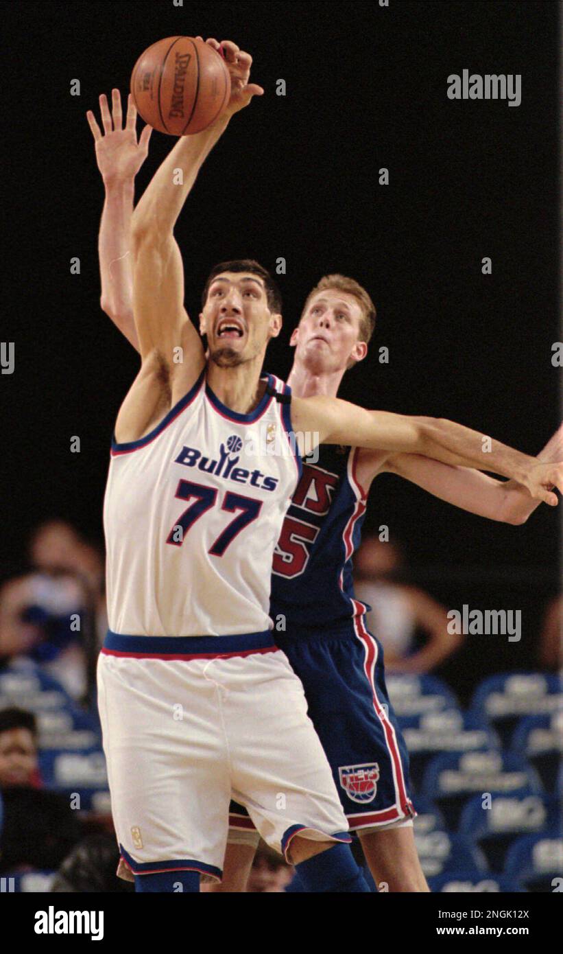 Washington Bullets Gheorghe Muresan grabs a pass under the basket in front  of New Jersey Nets Shawn Bradley during the first quarter in Baltimore  Friday, Feb. 14, 1997. (AP Photo/Roberto Borea Photo