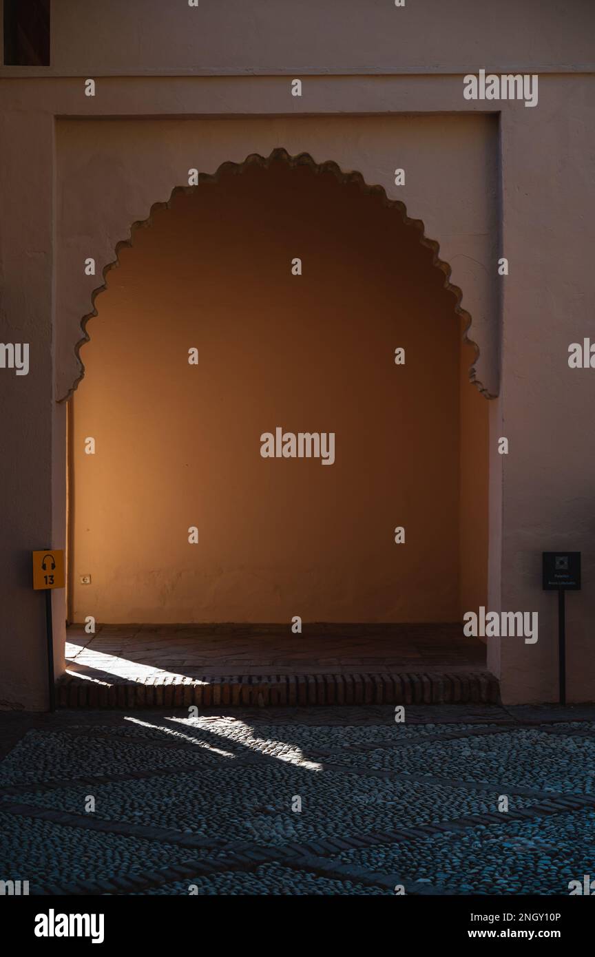 La lumière douce entre par la porte voûtée du palais Alcazaba à Malaga, en Espagne Banque D'Images La lumière douce entre par la porte voûtée du palais Alcazaba à Malaga, en Espagne Banque D'Images