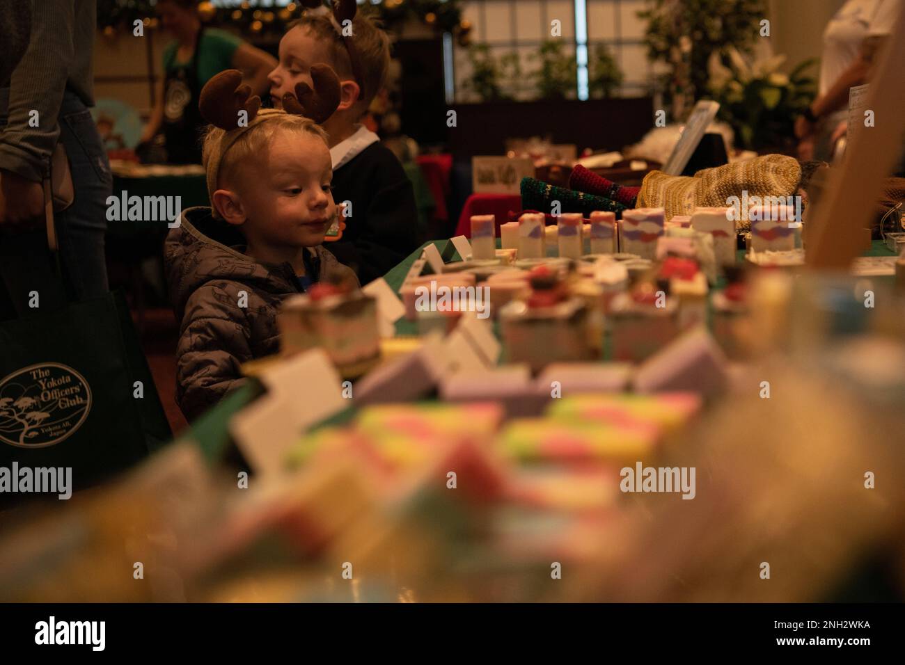 Les enfants de la communauté de Yokota regardent les kiosques du marché de Noël de l’escadron de soutien de la Force à la base aérienne de Yokota, au Japon, le 8 décembre 2022. Yokota a accueilli un marché de Noël, où la communauté de base pourrait participer à des activités sur le thème des vacances. La peinture faciale, la musique live, les photos avec le Père Noël et la nourriture étaient quelques-unes des activités proposées aux participants. Banque D'Images