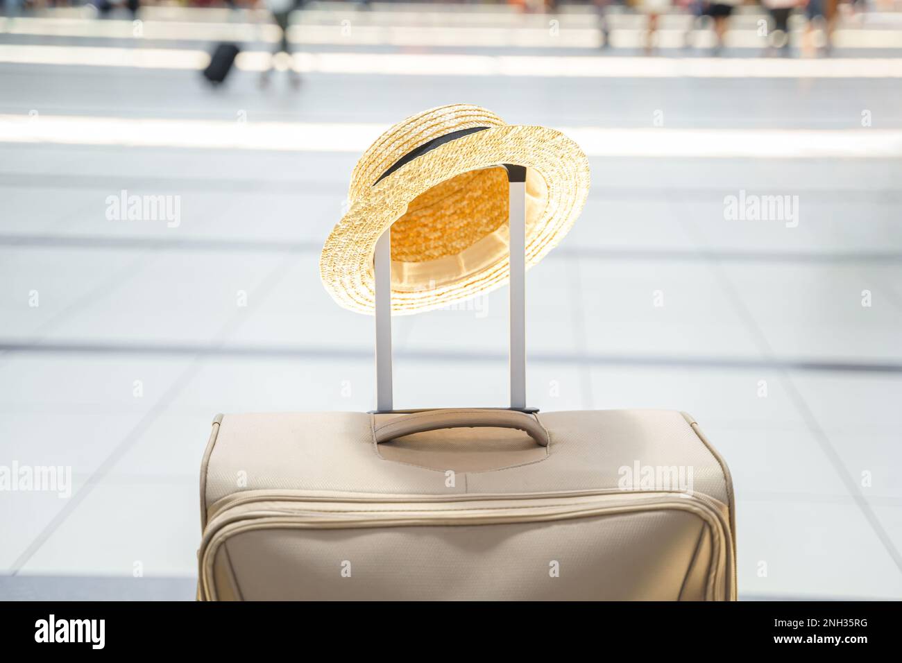 Chapeau de paille dans une grande valise, sac dans le terminal de l'aéroport. En attente de l'embarquement pour le vol. Vacances en famille. Enregistrement des bagages dans le hall des départs. S Banque D'Images