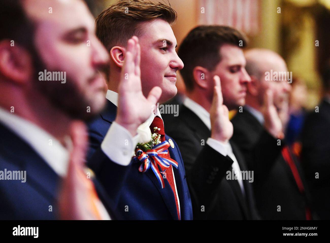 State Rep. Alec Ryncavage, center, raises up his hand as he is sworn in ...