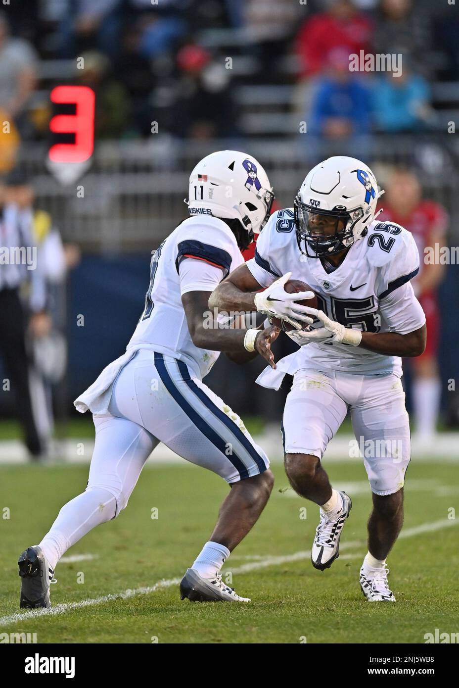 EAST HARTFORD, CT - OCTOBER 01: UConn Huskies running back Devontae Houston (25) takes the hand off from UConn Huskies quarterback Zion Turner (11) during the game as the Fresno State Bulldogs take on the UConn Huskies on October 1, 2022, at the Rentschler Field in East Hartford, Connecticut.(Photo by Williams Paul/Icon Sportswire) (Icon Sportswire via AP Images) Banque D'Images