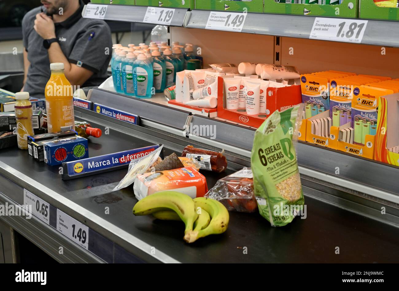 Nourriture sur le tapis convoyeur à la caisse du supermarché avec des articles de vente impulsifs, Lidl Banque D'Images