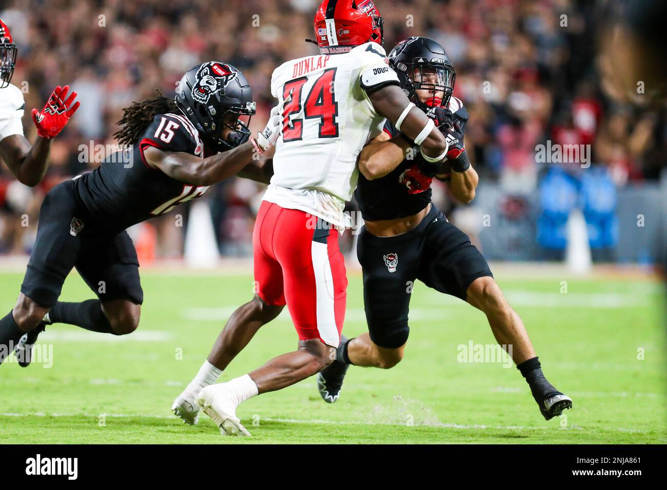 RALEIGH, NC - SEPTEMBER 17: Jordan Houston (3) of the North Carolina State Wolfpack is tackled by Malik Dunlap (24) of the Texas Tech Red Raiders during a football game between the North Carolina State Wolfpack and the Texas Tech Red Raiders on September 17, 2022, at Carter-Finley Stadium in Raleigh, NC. (Photo by David Jensen/Icon Sportswire) (Icon Sportswire via AP Images) Banque D'Images
