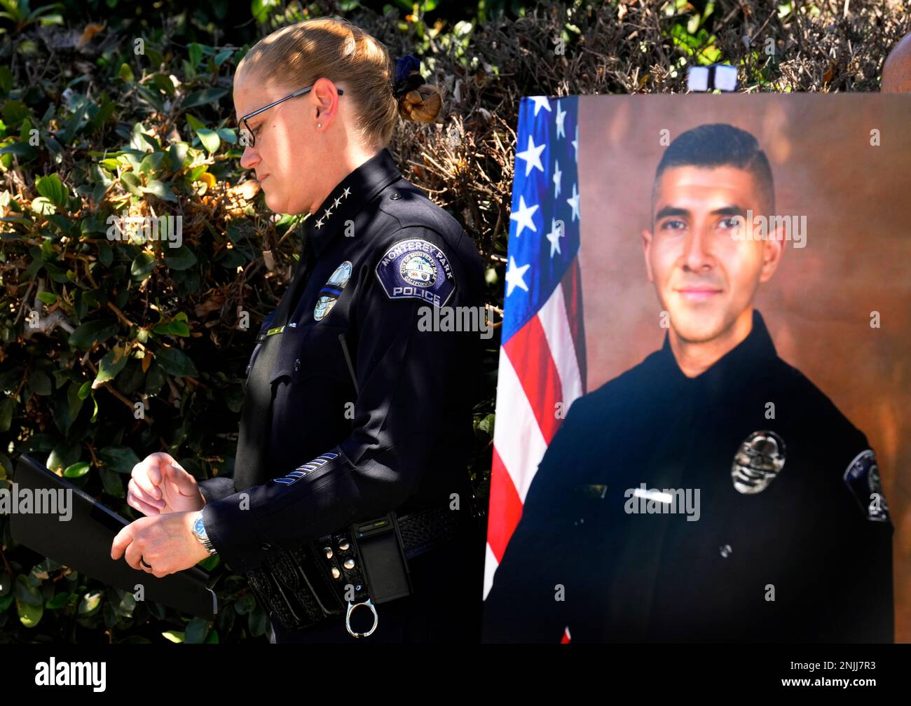 Monterey Park Chief of Police Kelly Gordon stands next to a picture