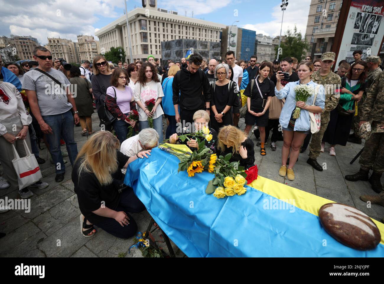 People mourn and lay a bouquet of flowers for a Ukrainian soldier who died in the battle of eastern Ukraine against the Russian troops at the Independence Square in Kyiv, the capital of Ukraine on June 18, 2022. According to the Ukraine government, more than 10,000 military personnel have been killed.( The Yomiuri Shimbun via AP Images ) Banque D'Images