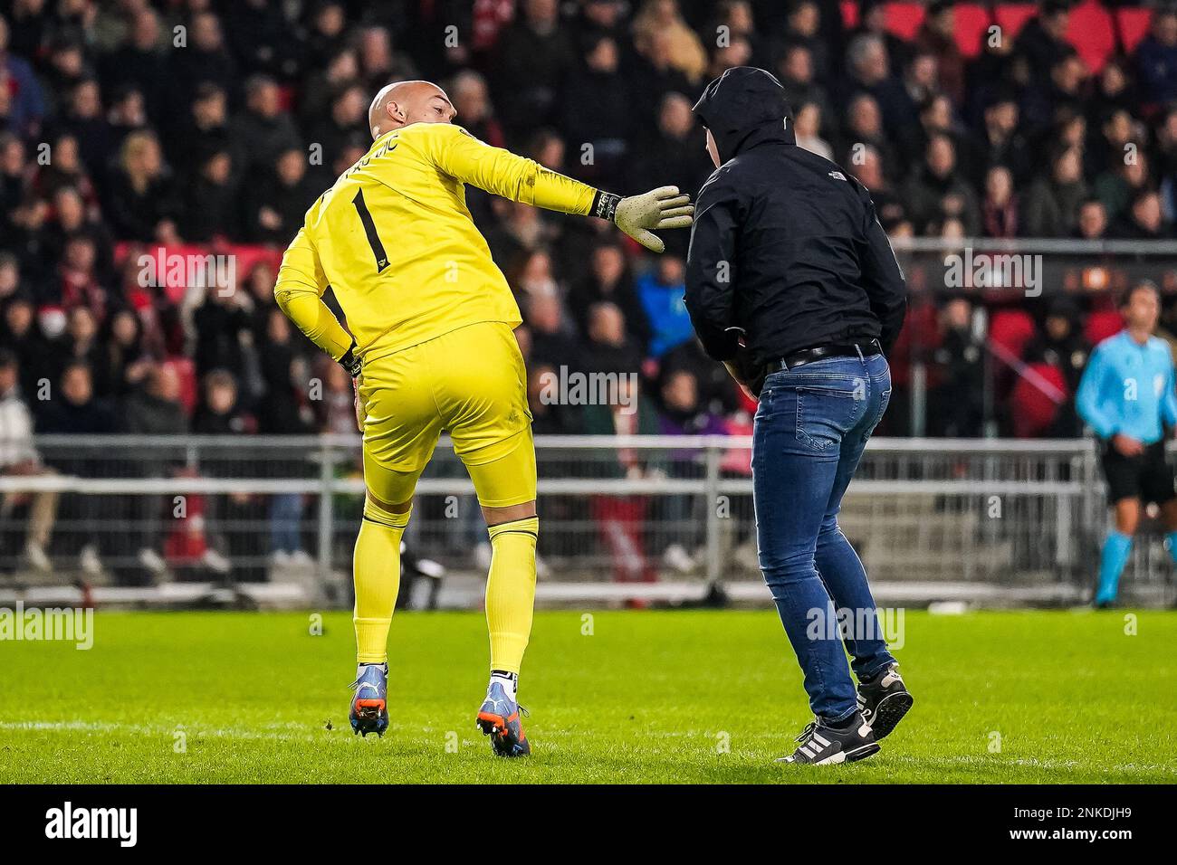 EINDHOVEN, PAYS-BAS - FÉVRIER 23 : Marko Dmitrovic du FC Sevilla est attaqué par un supporter qui a envahi le terrain pendant le match de l'UEFA Europa League Knockout Round Play-Off Leg Two entre le PSV et le FC Sevilla au stade Philips sur 23 février 2023 à Eindhoven, pays-Bas (photo de René Nijhuis/Orange Pictures) Banque D'Images