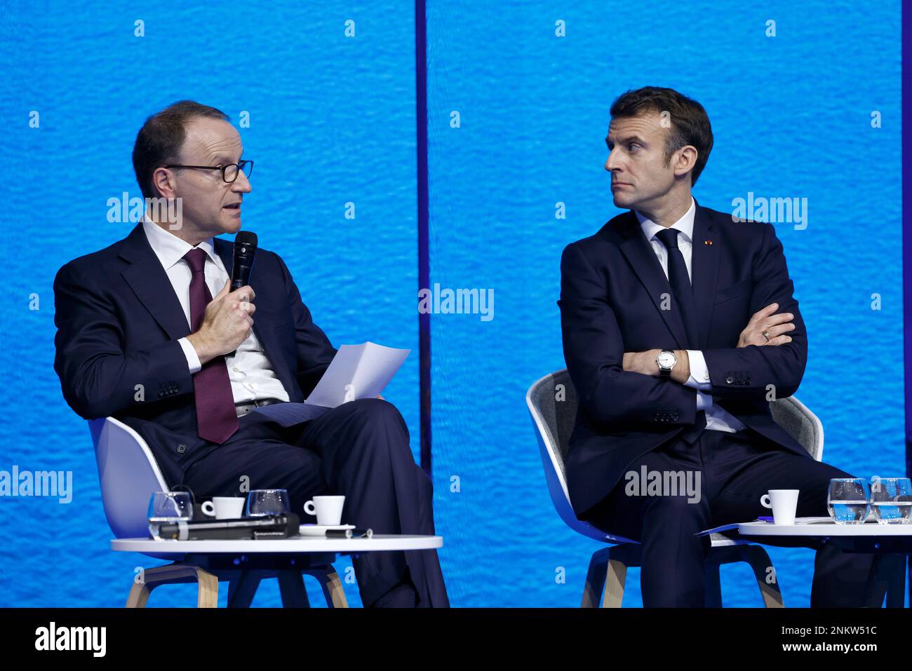 France's President Emmanuel Macron, right, listens as Swiss food giant