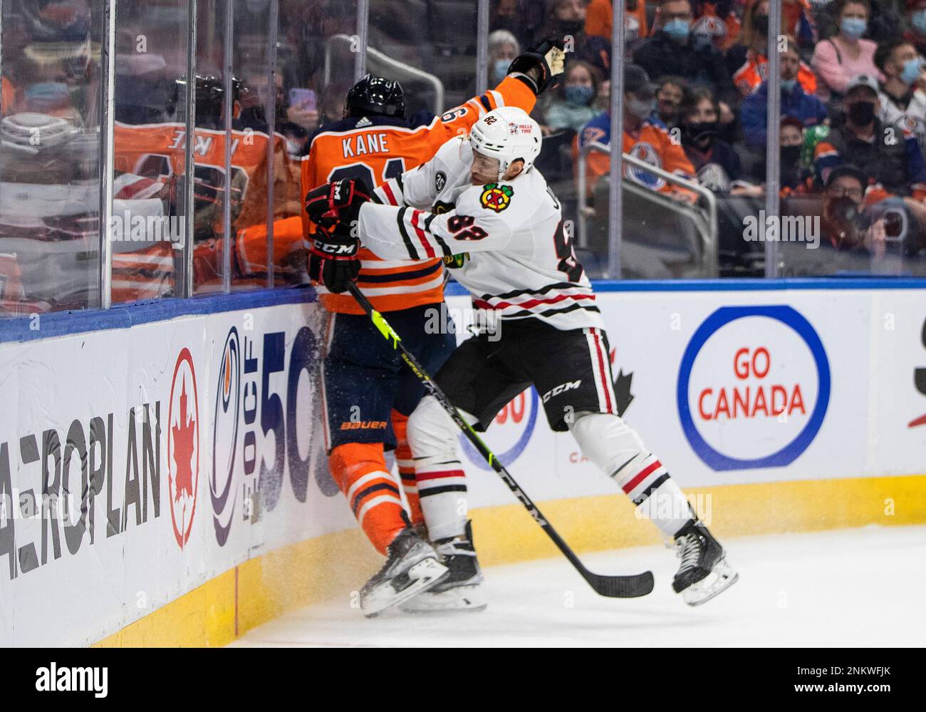 Chicago Blackhawks' Caleb Jones (82) checks Edmonton Oilers' Evander Kane (91) during the second period of an NHL hockey game Wednesday, Feb. 9, 2022, in Edmonton, Alberta. (Jason Franson/The Canadian Press via AP) Banque D'Images