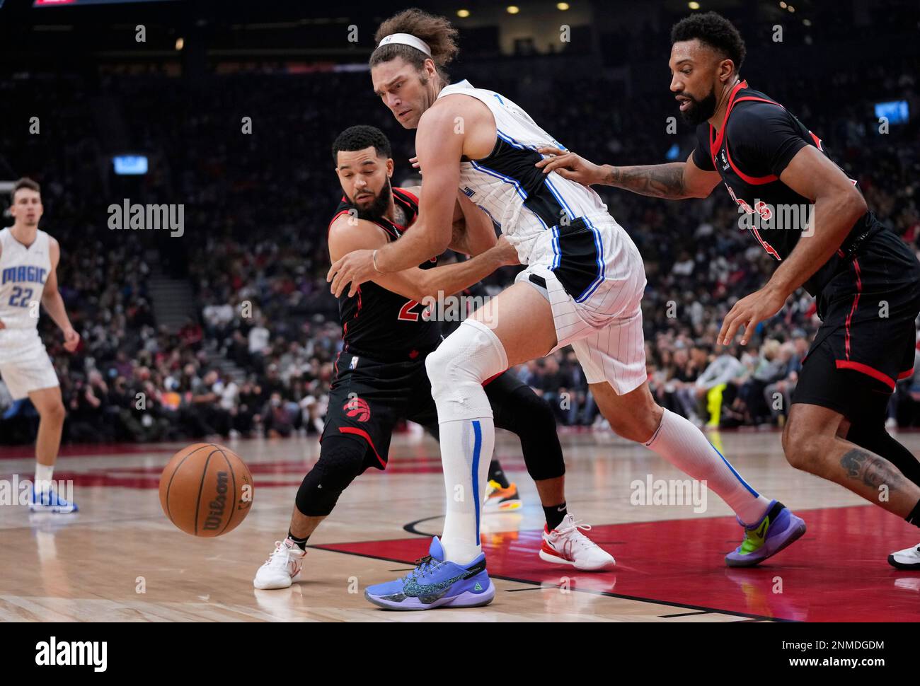 Orlando Magic centre Robin Lopez and Toronto Raptors guard Fred VanVleet (23) and center Khem Birch (24) watch the ball during the first half of an NBA basketball game Friday, Oct. 29, 2021, in Toronto. (Nathan Denette/The Canadian Press via AP) Banque D'Images
