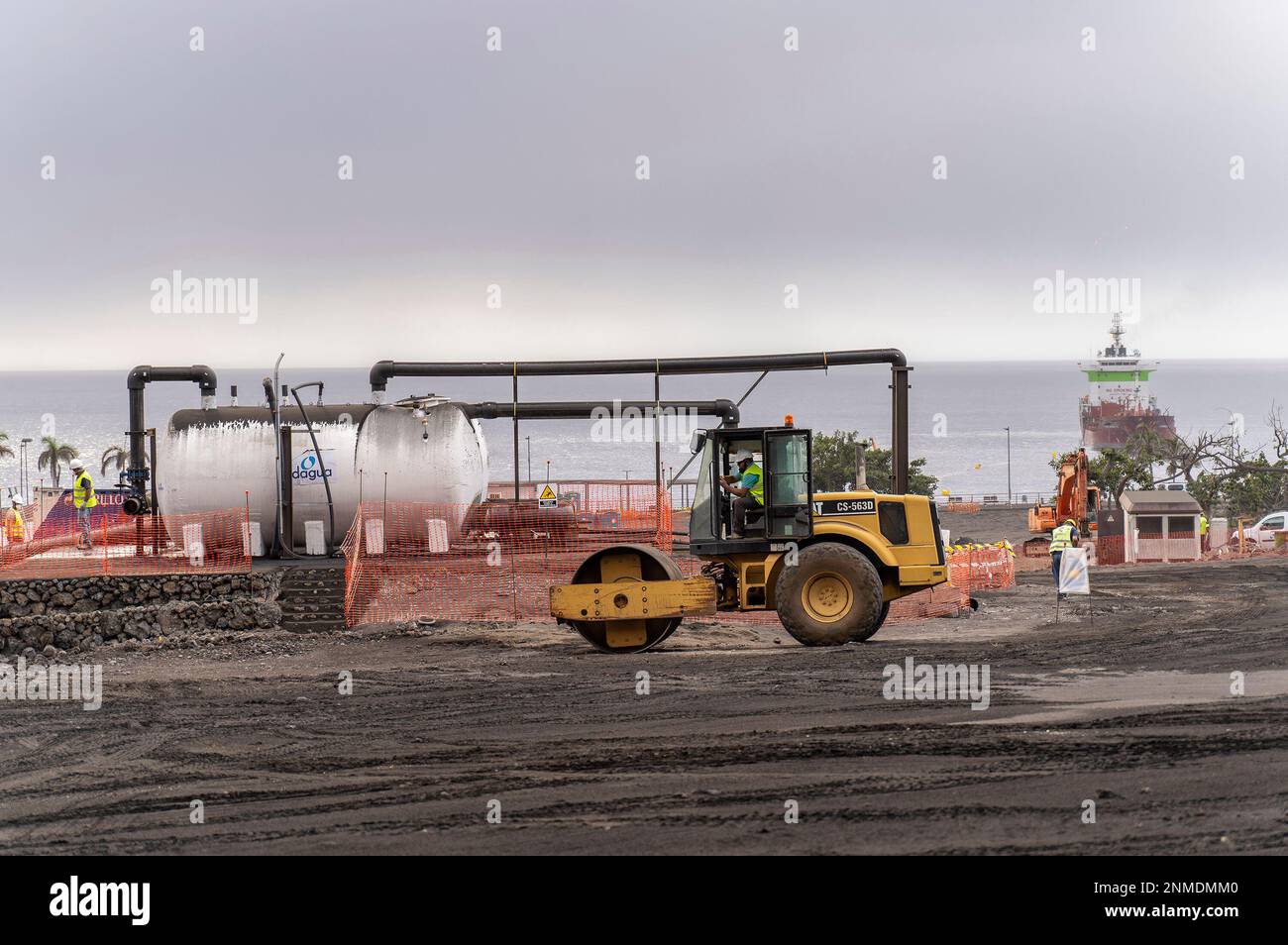 Workers work in the area where several portable desalination