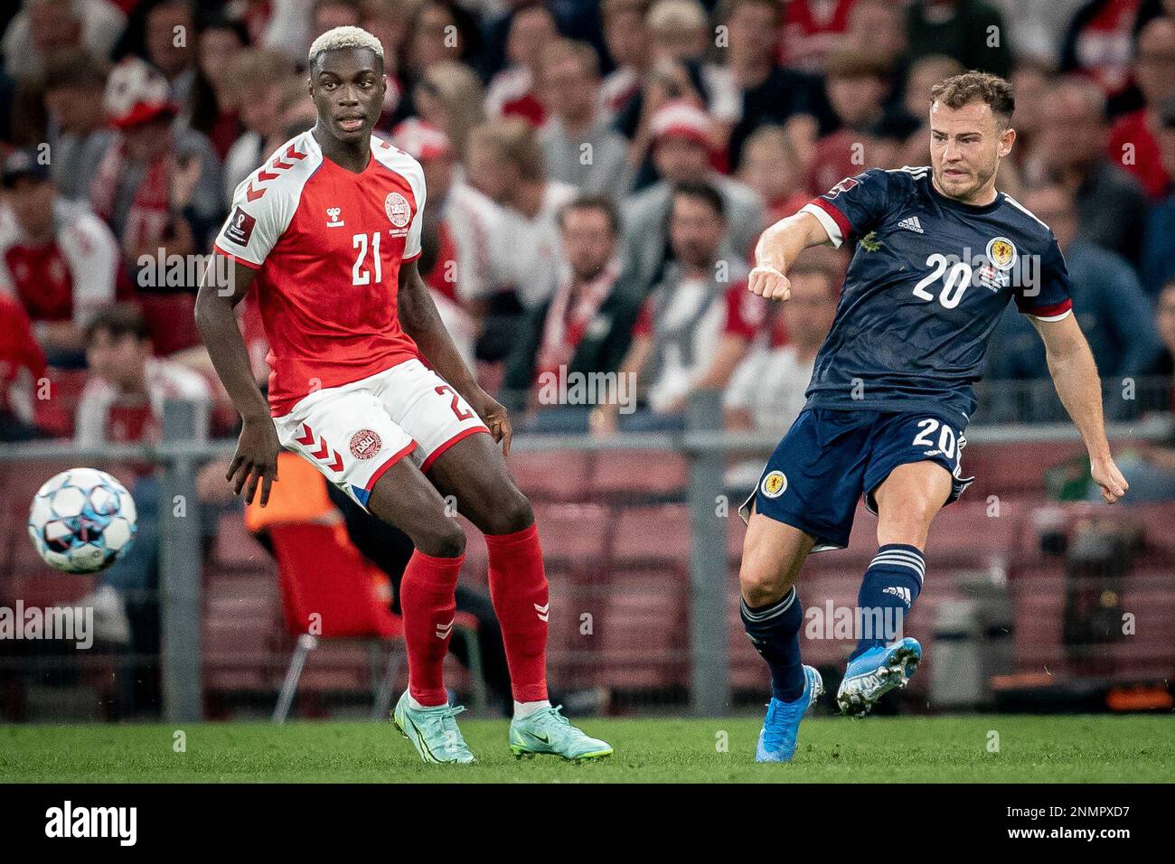 Denmark's Mohamed Daramy, left, and Scotland's Ryan Fraser, right, fight for the ball during the World Cup 2022 qualifying soccer match between Denmark and Scotland at Parken Stadium in Copenhagen, Wednesday Sept. 1, 2021. (Mads Claus Rasmussen/Ritzau Scanpix via AP) Banque D'Images