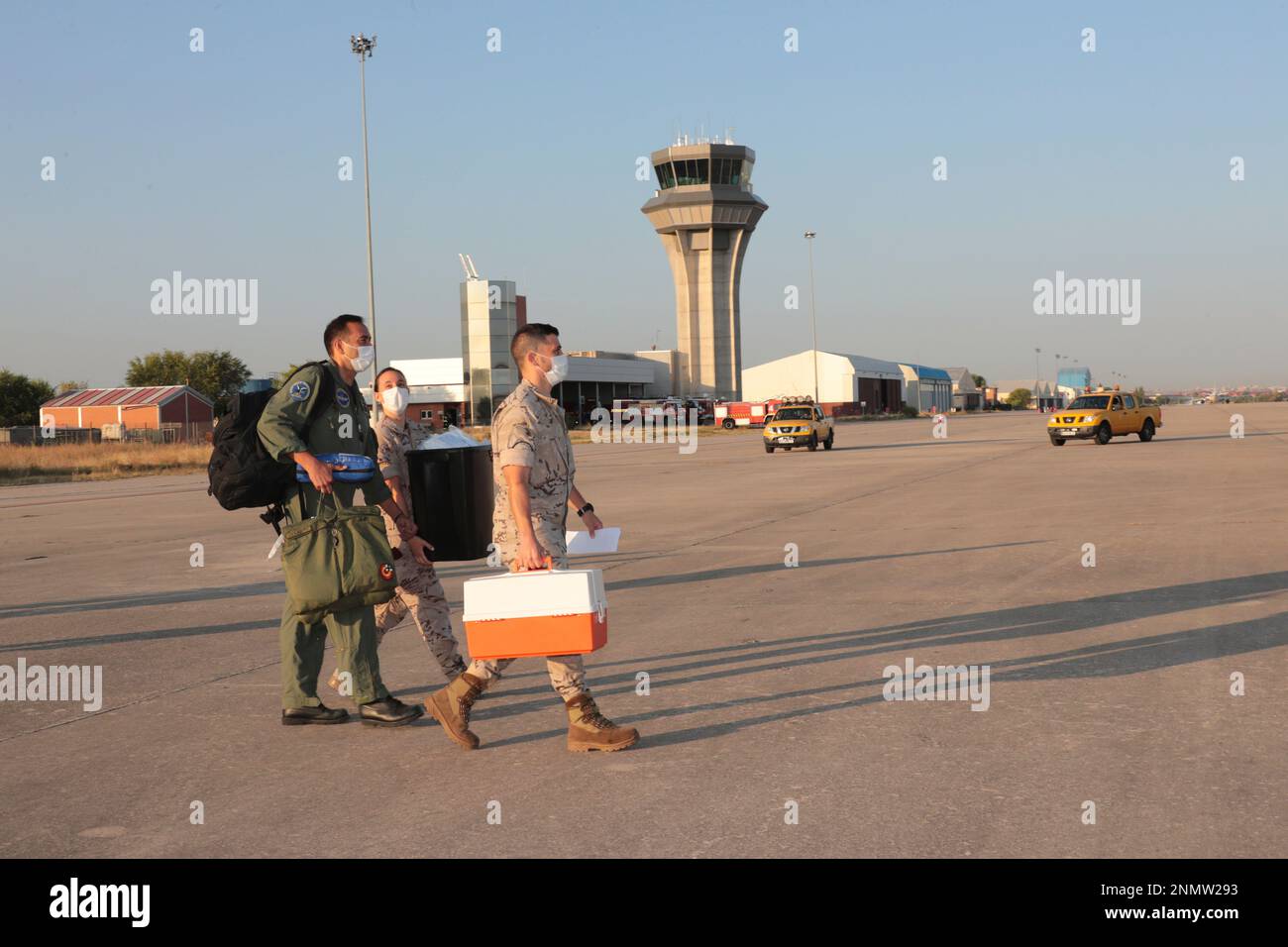 Military personnel are on their way to board the plane that has taken off from Dubai to Kabul to
