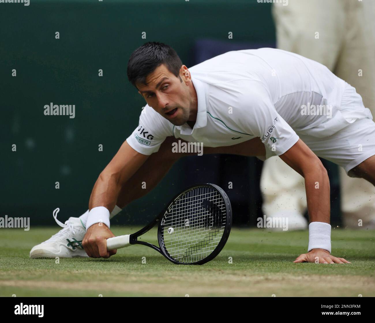 Novak Djokovic of Serbia falls down during the men's singles semifinal of the Championships, Wimbledon against Denis Shapovalov of Canada at the All England Lawn Tennis and Croquet Club in London, United Kingdom on July 9, 2021. ( The Yomiuri Shimbun via AP Images ) Banque D'Images