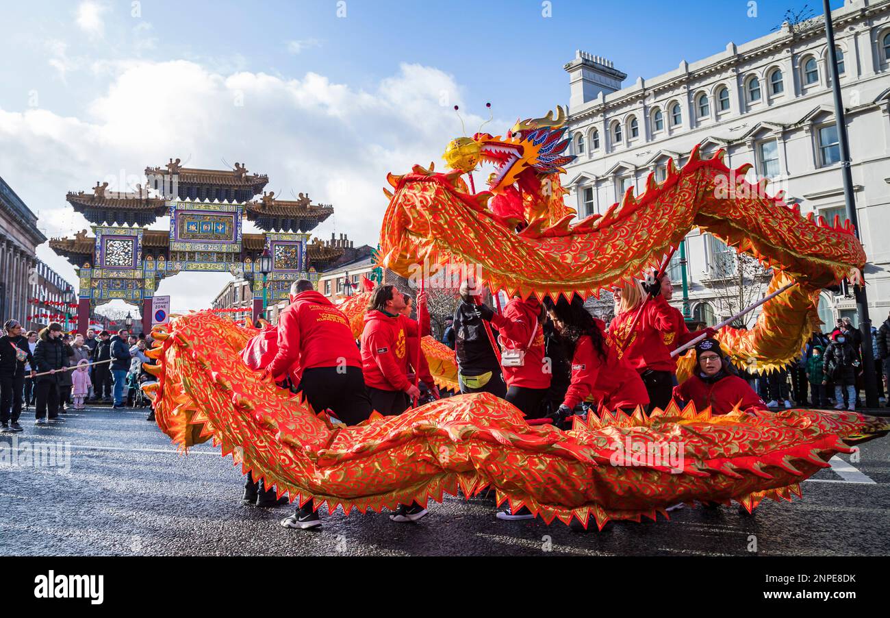 Le dragon s'enroule pendant la danse du dragon devant le Paifang lors des célébrations du nouvel an chinois dans le quartier chinois de Liverpool. Banque D'Images