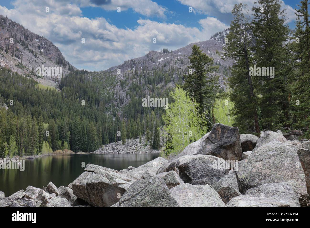 Un seul kayakiste sur le lac Weller, entouré de montagnes couvertes d'Evergreen et d'Aspens et de grands rochers au Colorado, aux États-Unis Banque D'Images