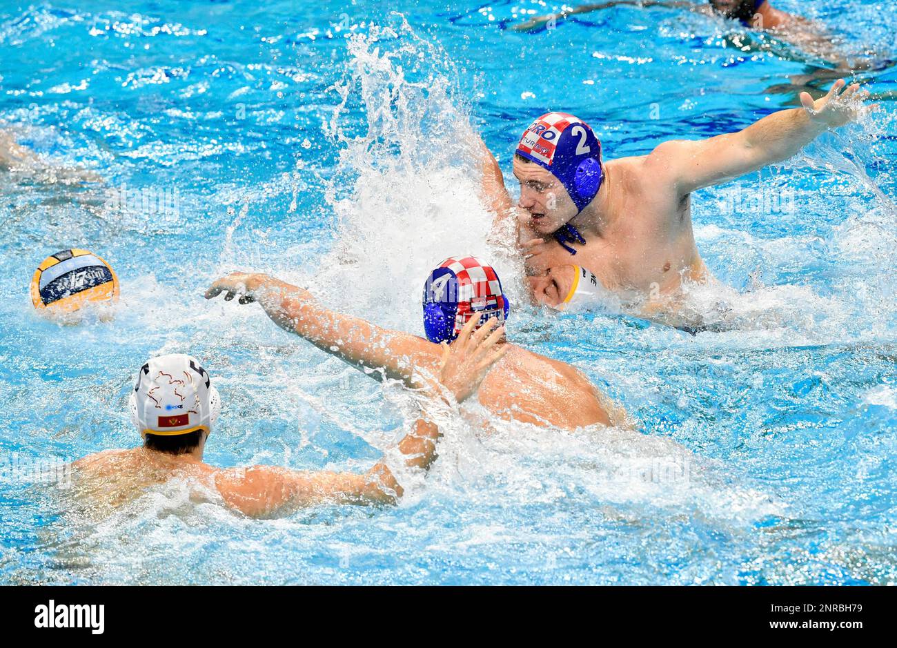 Vladan Spaic, second right, of Montenegro is challenged by Luka Loncar, second left, and Marko Macan, right, of Croatia for the ball during men's European Water Polo Championship match Montenegro vs. Croatia for the bronze medal in Budapest, Hungary, Sunday, Jan. 26, 2020. (Zsolt Szigetvary/MTI via AP) Banque D'Images