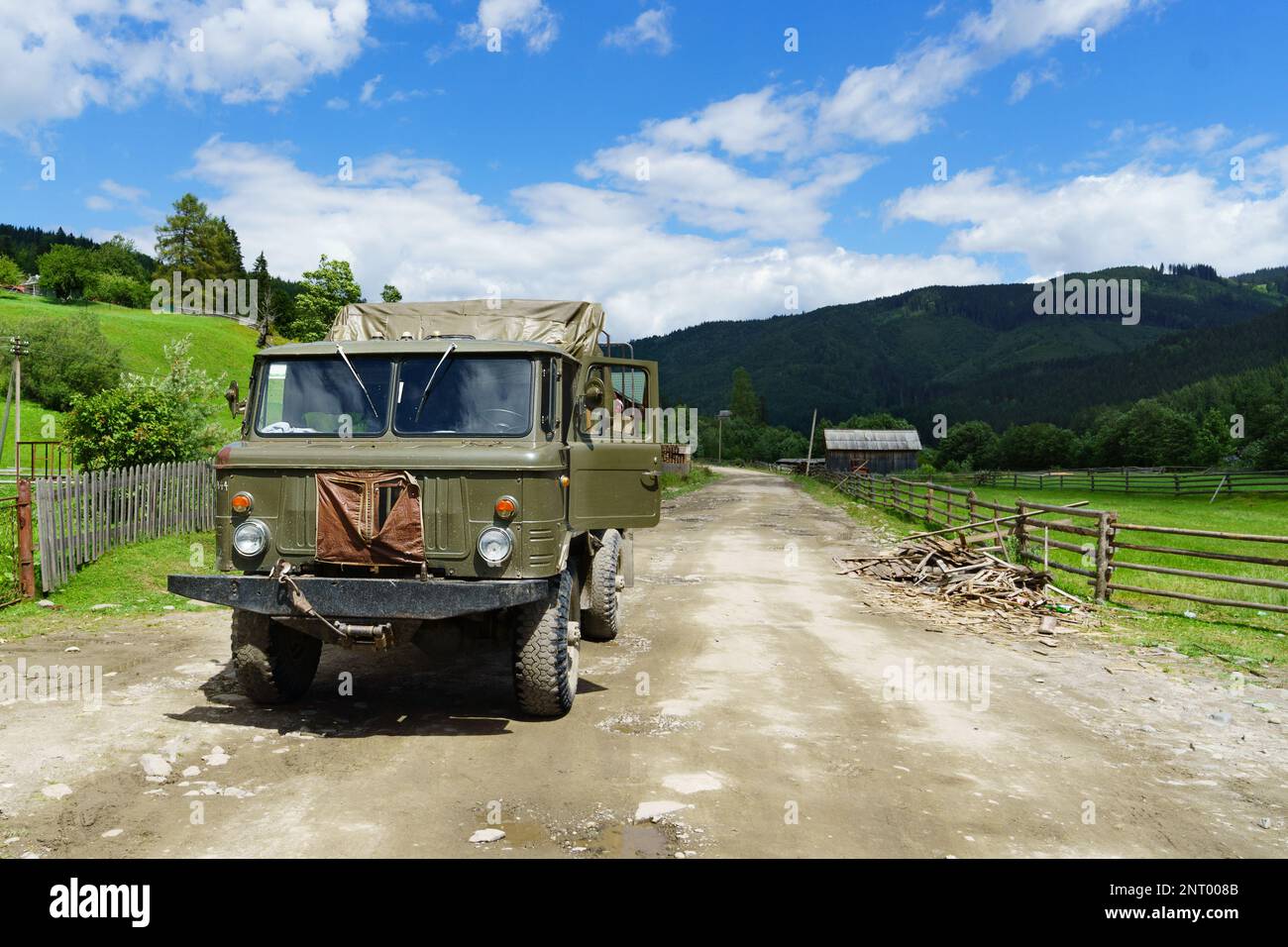 Lourd puissant vieux camion vert militaire soviétique sur la route de campagne montagnes. Contexte du concept de survie horizontale. Banque D'Images