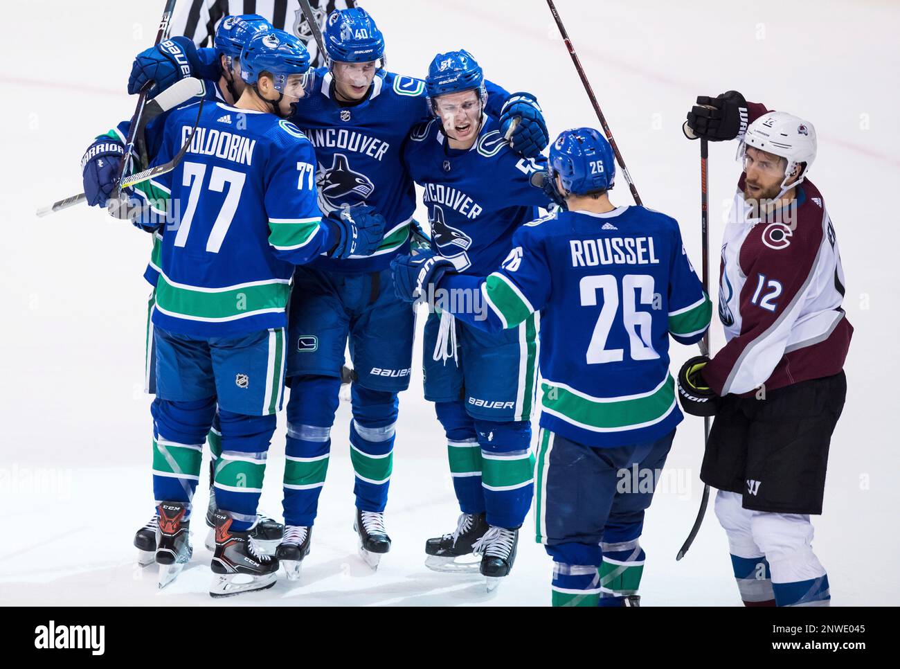 Vancouver Canucks' Derrick Pouliot; Nikolay Goldobin, of Russia; Elias Pettersson, of Sweden; Troy Stecher; and Antoine Roussel, of France, from left, celebrate Pettersson's goal as Colorado Avalanche defenseman Patrik Nemeth (12), of Sweden, skates past during the second period of an NHL hockey game Friday, Nov. 2, 2018, in Vancouver, British Columbia. (Darryl Dyck/The Canadian Press via AP) Banque D'Images