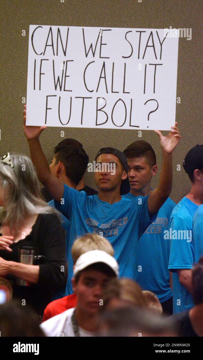 FILE - In this July 19, 2018 file photo, Cleveland High School soccer player Mariano Barreras, of Rio Rancho, N.M., holds up a sign supporting the University of New Mexico men's soccer program, during the Board of Regents meeting in the Student Union, in Albuquerque, N.M. New Mexico's attorney general is slamming the state's largest university over "flagrant abuse" of the state's transparency laws. (Greg Sorber /The Albuquerque Journal via AP, File) Banque D'Images