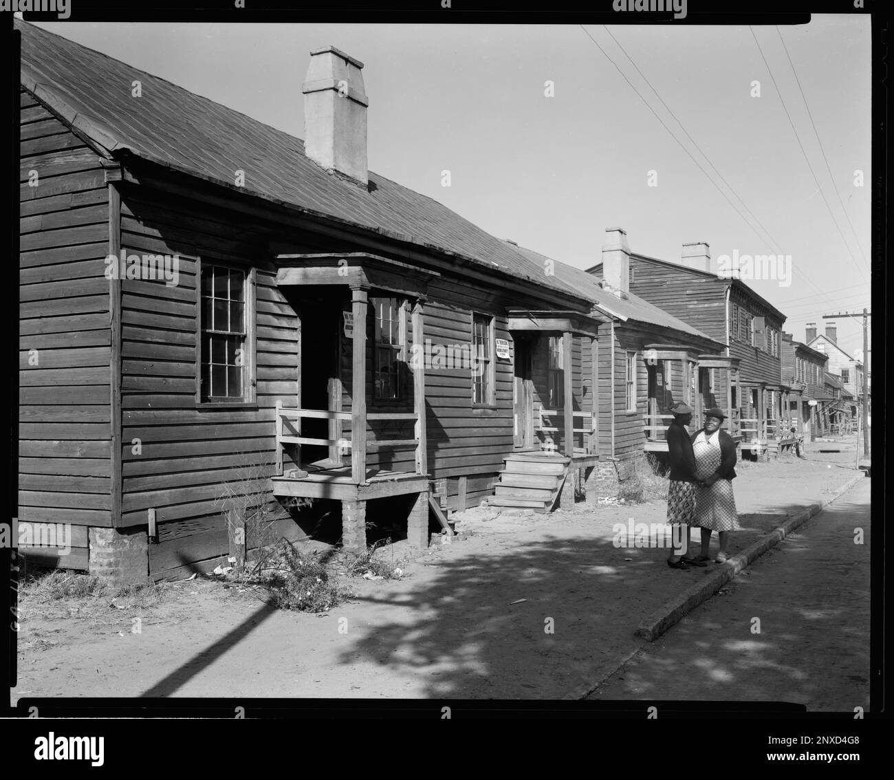 Fahn Street, West Side, Savannah, Chatham County, Géorgie. Carnegie Etude de l'architecture du Sud. États-Unis, Géorgie, Chatham County, Savannah, trottoirs, Maisons en rangée, Porches, bâtiments en bois, femmes. Banque D'Images