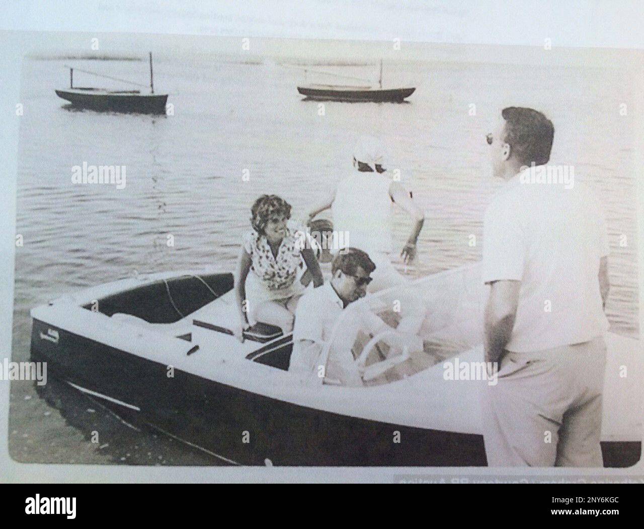 FILE- In this undated file photo provided by Guernsey's, John F. Kennedy is at the wheel of his speedboat, Restofus. Hot memorabilia with a Cold War theme, including property of the late President John F. Kennedy and CIA pilot Francis Gary Powers, is being featured at an auction in New York City on Saturday, Oct. 7, 2017. (Guernsey's via AP) Banque D'Images