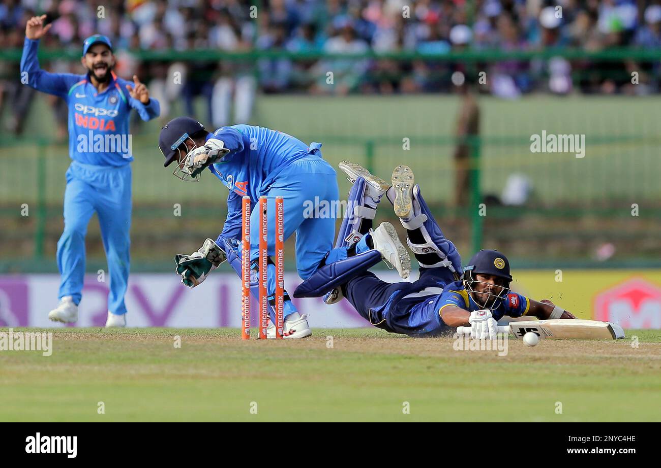 Sri Lanka's Dinesh Chandimal, right, dives to make it successfully to the crease during their third one-day international cricket match against India in Pallekele, Sri Lanka, Sunday, Aug. 27, 2017. (AP Photo/Eranga Jayawardena) Banque D'Images