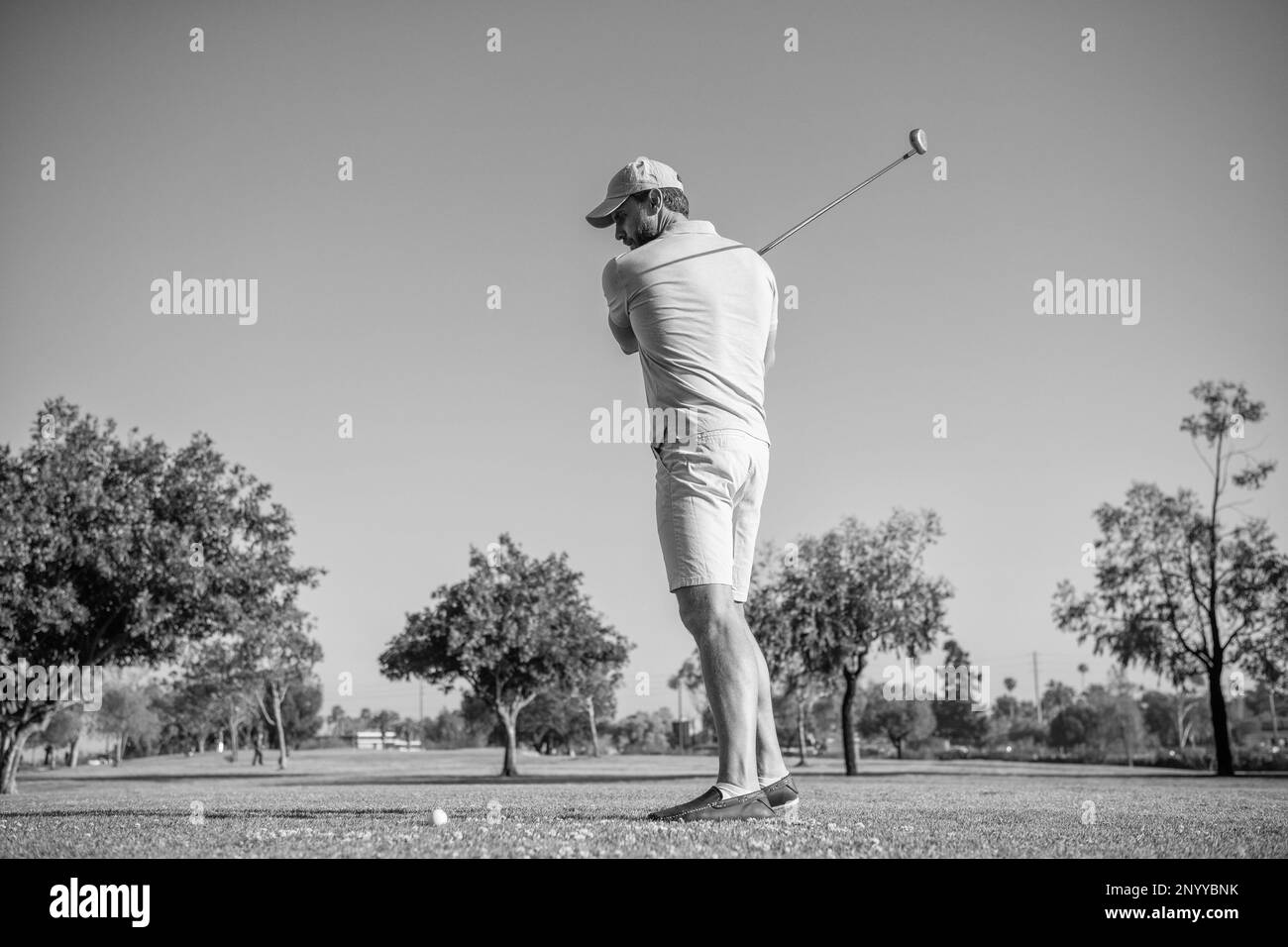 golfeur en casquette avec club de golf, golf Banque D'Images