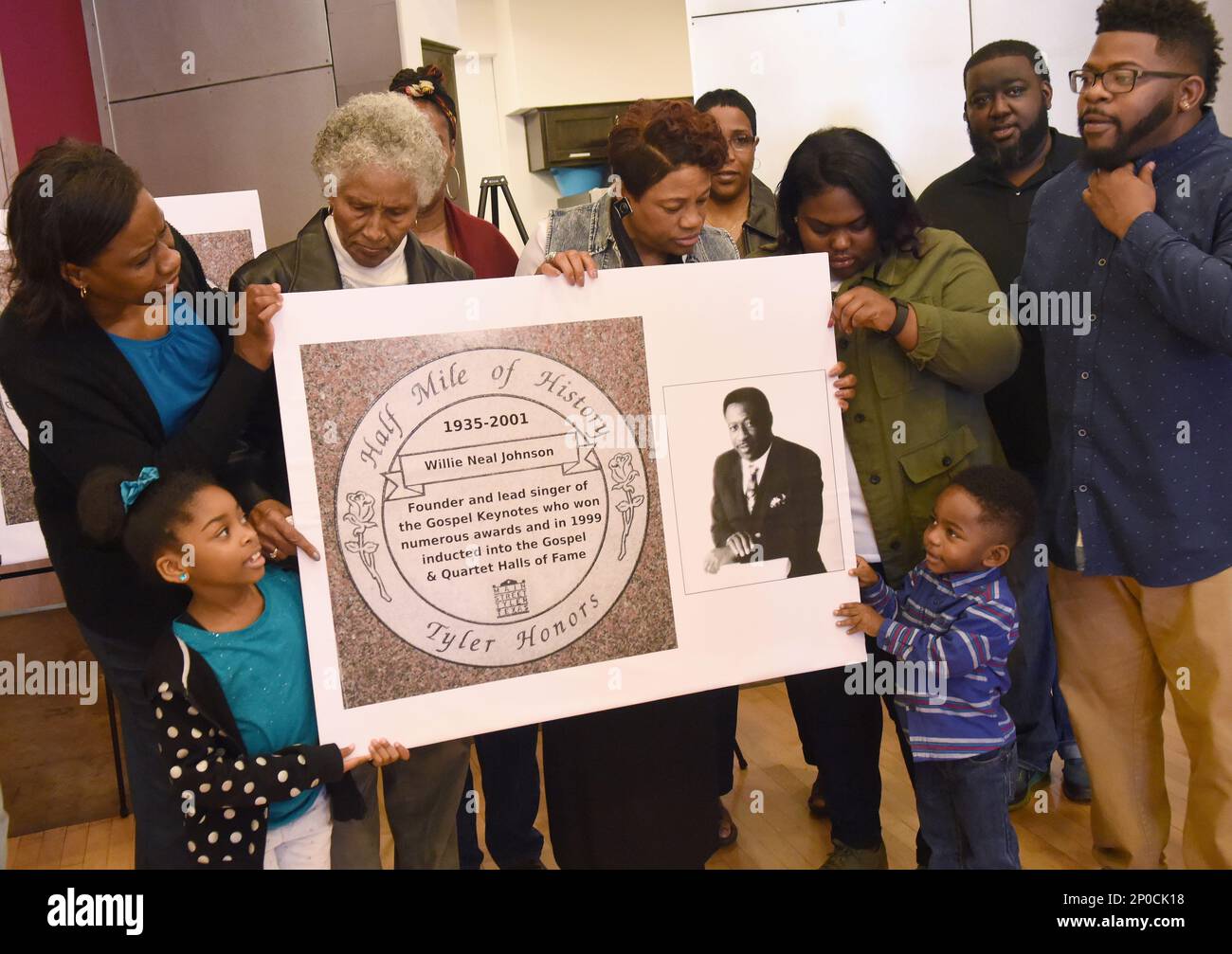 Relatives of Willie Neal Johnson hold a rendering of his Half Mile of