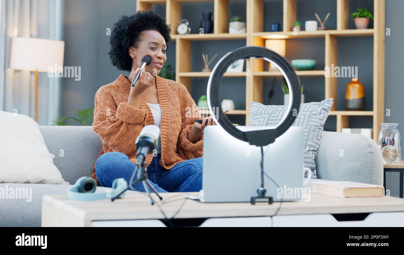 Une influenceur féminine enregistrant un didacticiel de maquillage pour son blog de beauté ou son canal de diffusion en direct à la maison. Jeune femme créant du contenu et s'engageant avec Banque D'Images