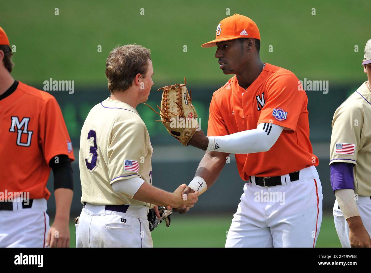 Center fielder Kyle Lewis (20) of the Mercer Bears shakes hands with J.D Long (3) after winning a SoCon Tournament game against Western Carolina on Saturday, May 28, 2016, at Fluor Field at the West End in Greenville, South Carolina. Mercer won, 9-8. (Tom Priddy/Four Seam Images via AP Images) Banque D'Images