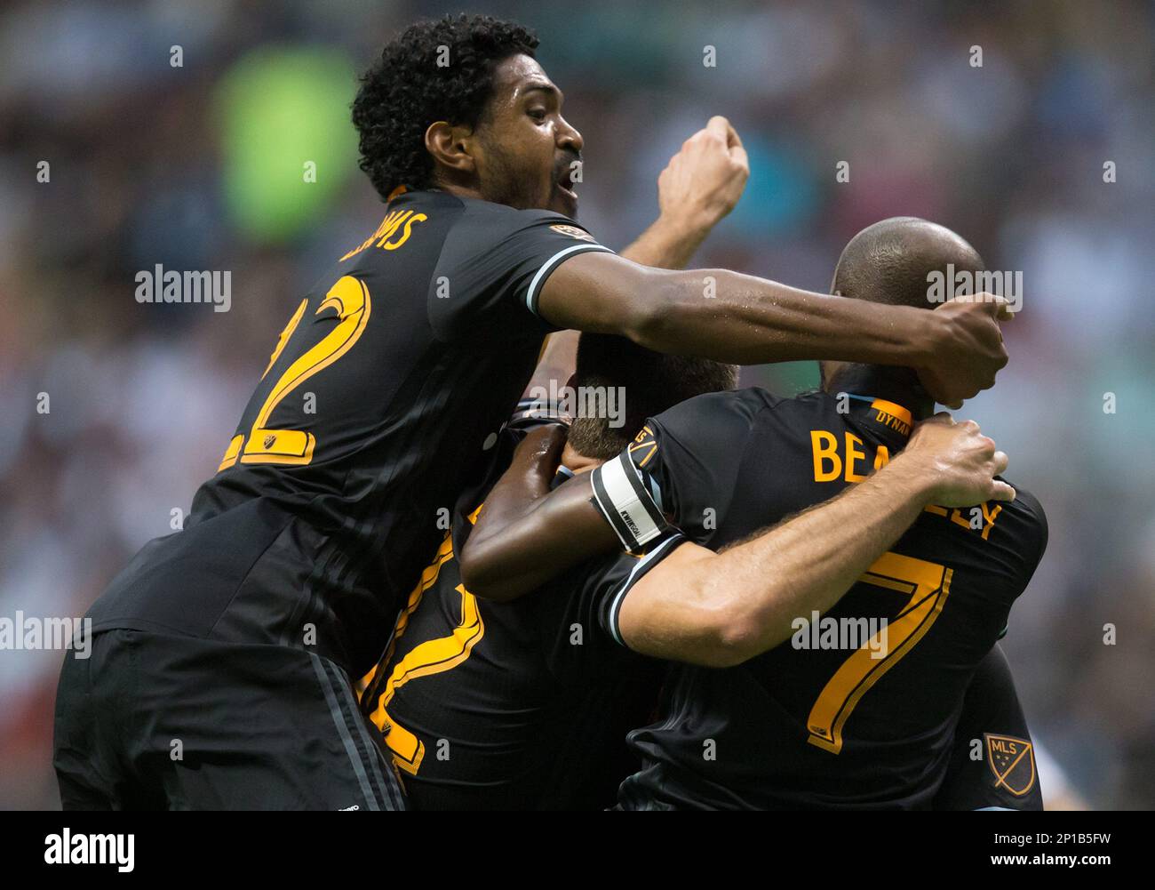 Houston Dynamo's Sheanon Williams, from left, Will Bruin and DaMarcus Beasley celebrate Beasley's goal against the Vancouver Whitecaps during the first half of an MLS soccer game in Vancouver, British Columbia, Saturday May 28, 2016. (Darryl Dyck/The Canadian Press via AP) Banque D'Images