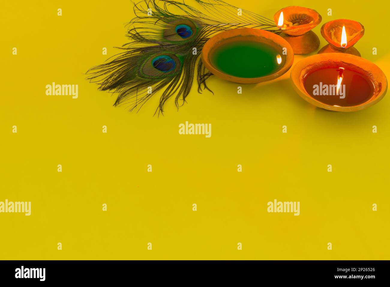 joyeux holi célébration avec des couleurs, une lampe d'argile et la plume de paon symbolisant le dieu hindou krishna. Holi ou dol yatra est largement célébré dans toute l'inde A. Banque D'Images