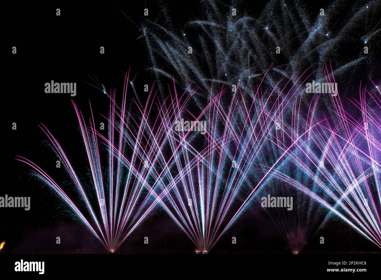 joyeuses fêtes du nouvel an la veille du nouvel an feux d'artifice colorés à la pyrotechnique dans le ciel noir foncé avec l'image de la fusée de couleur réflecte Banque D'Images