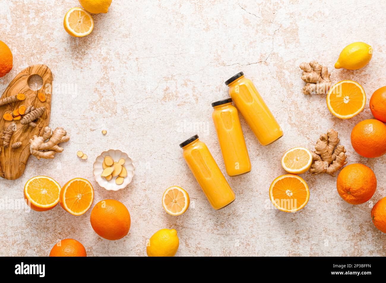 Smoothie. Smoothie aux agrumes Detox frais et sain avec de l'orange, du citron, du gingembre et du curcuma dans des bouteilles en verre sur une table. Alimentation saine alimentation végétalienne pleine Banque D'Images