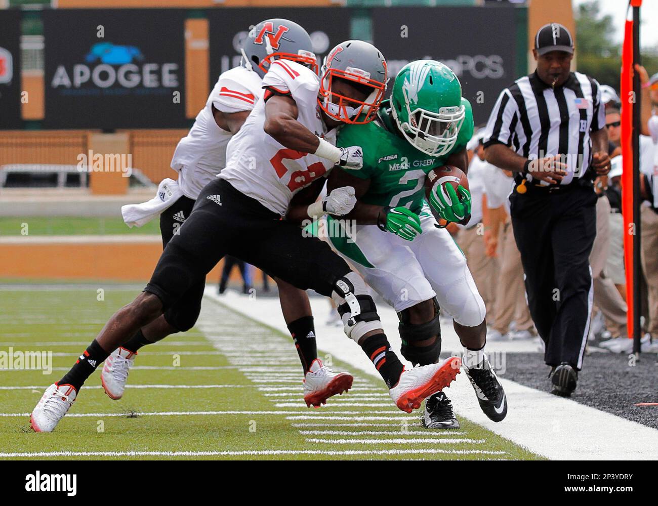 20 SEPTEMBER 2014: North Texas Mean Green running back Reggie Pegram (2) is knocked out of bounds by Nicholls State Colonels defensive back Christian Boutte (14) and Nicholls State Colonels linebacker Davin Bovie (28) during a NCAA football game between the North Texas Mean Green and the Nicholls State Colonels at Apogee Stadium in Denton, Texas. (Icon Sportswire via AP Images) Banque D'Images