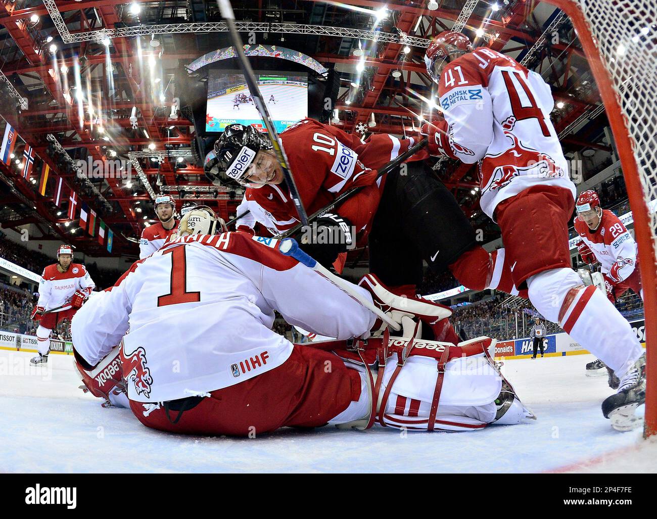 Team Canada's Brayden Schenn (10) is pushed over Denmark goalie Patrick Galbraith (1) by Jesper Jensen (41) during first period action at the IIHF World Hockey Championship in Minsk, Belarus, Thursday, May 15, 2014. (AP Photo/The Canadian Press, Jacques Boissinot) Banque D'Images