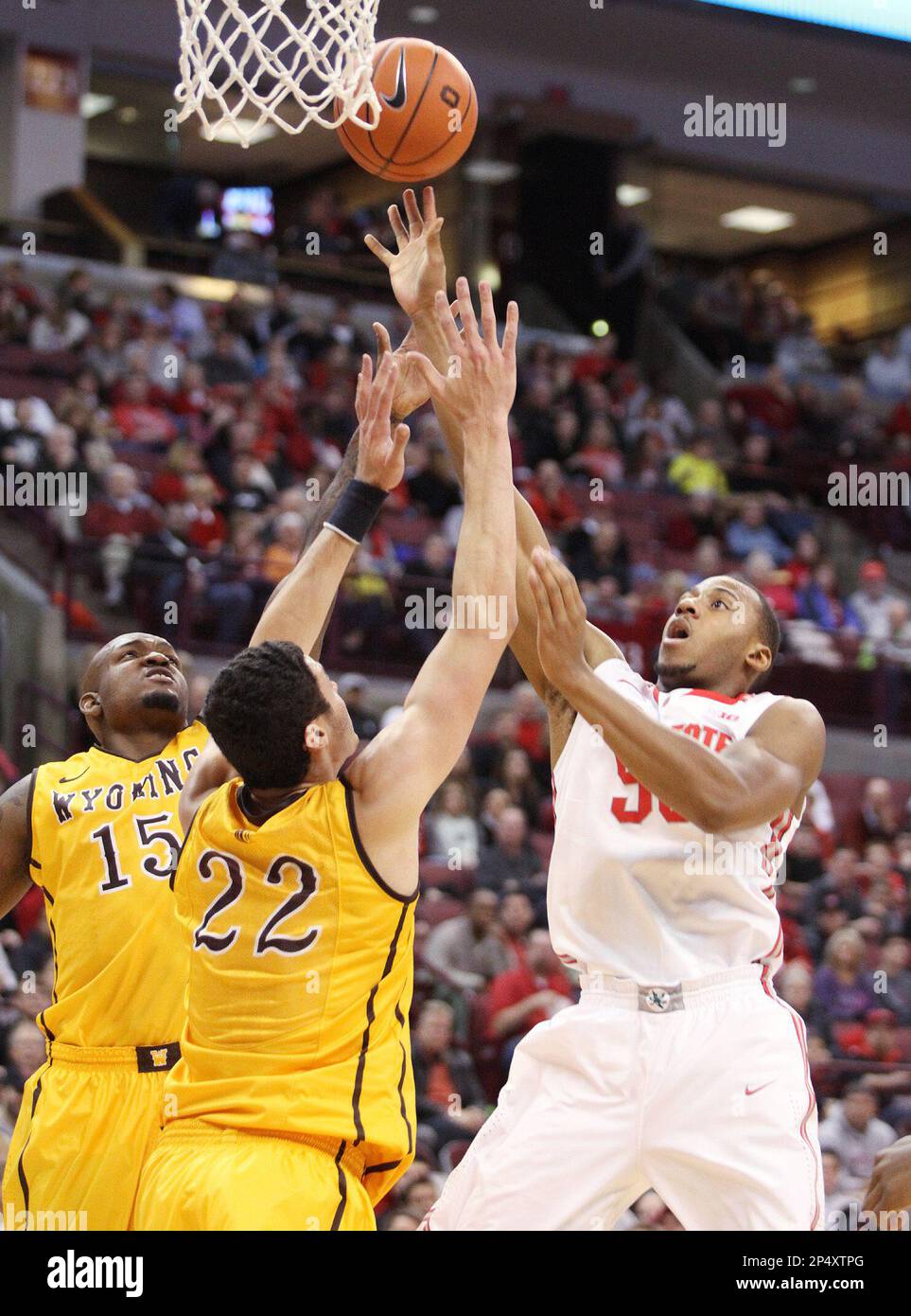 Ohio State's Trey McDonald (55) puts up a shot against Wyoming's Larry Nance, Jr. (22) and Jerron Granberry (15) during the first half of an NCAA college basketball game, Monday, Nov. 25, 2013, in Columbus, Ohio. (AP Photo/Mike Munden) Banque D'Images