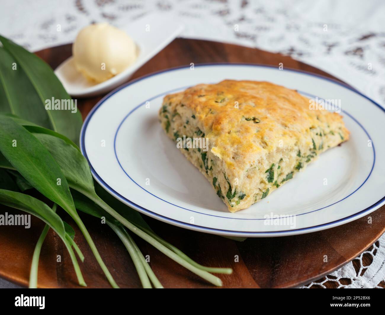 Scones à l'ail sauvage et savoureux faits maison et quelques feuilles d'ail sauvage. Banque D'Images