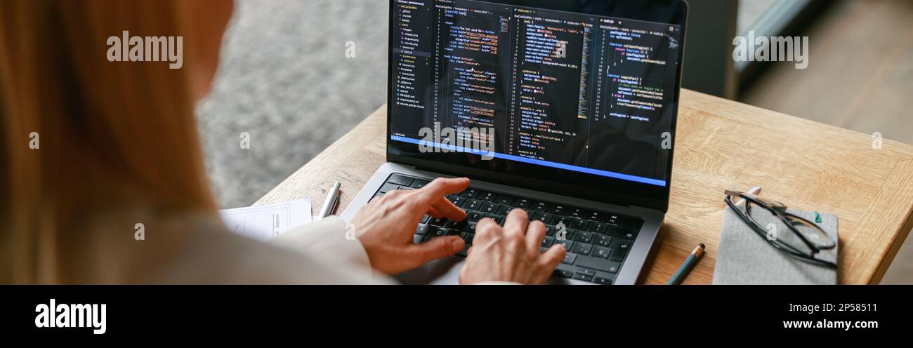 Gros plan sur une femme indépendante qui travaille sur un ordinateur portable tout en étant assise dans un café. Données correctes Banque D'Images