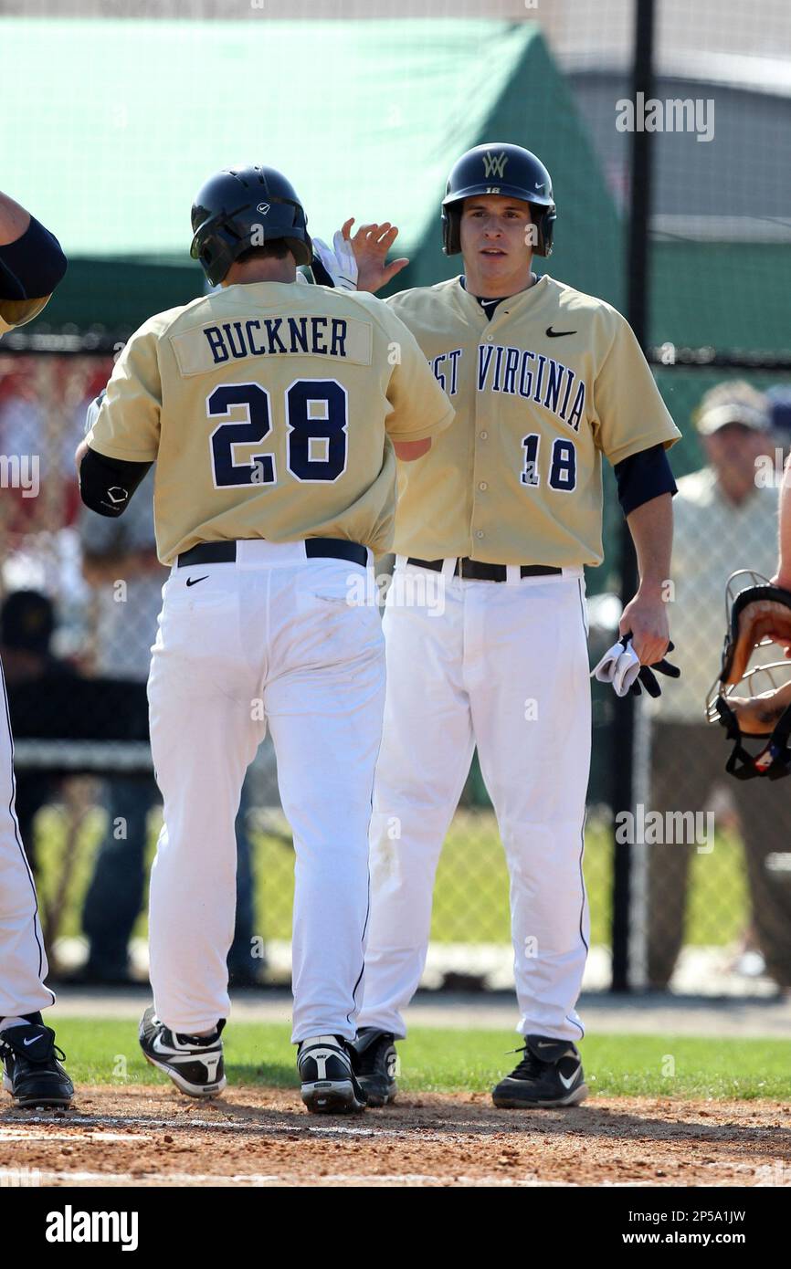 Second baseman Dan DiBartolomeo #18 of the West Virginia Mountaineers greets Grant Buckner after hitting a home run during the Big East-Big Ten Challenge vs. the Iowa Hawkeyes at Jack Russell Stadium in Clearwater, Florida; February 18, 2011. West Virginia defeated Iowa 5-0 in both teams opening games of the season. (Mike Janes/Four Seam Images via AP Images) Banque D'Images