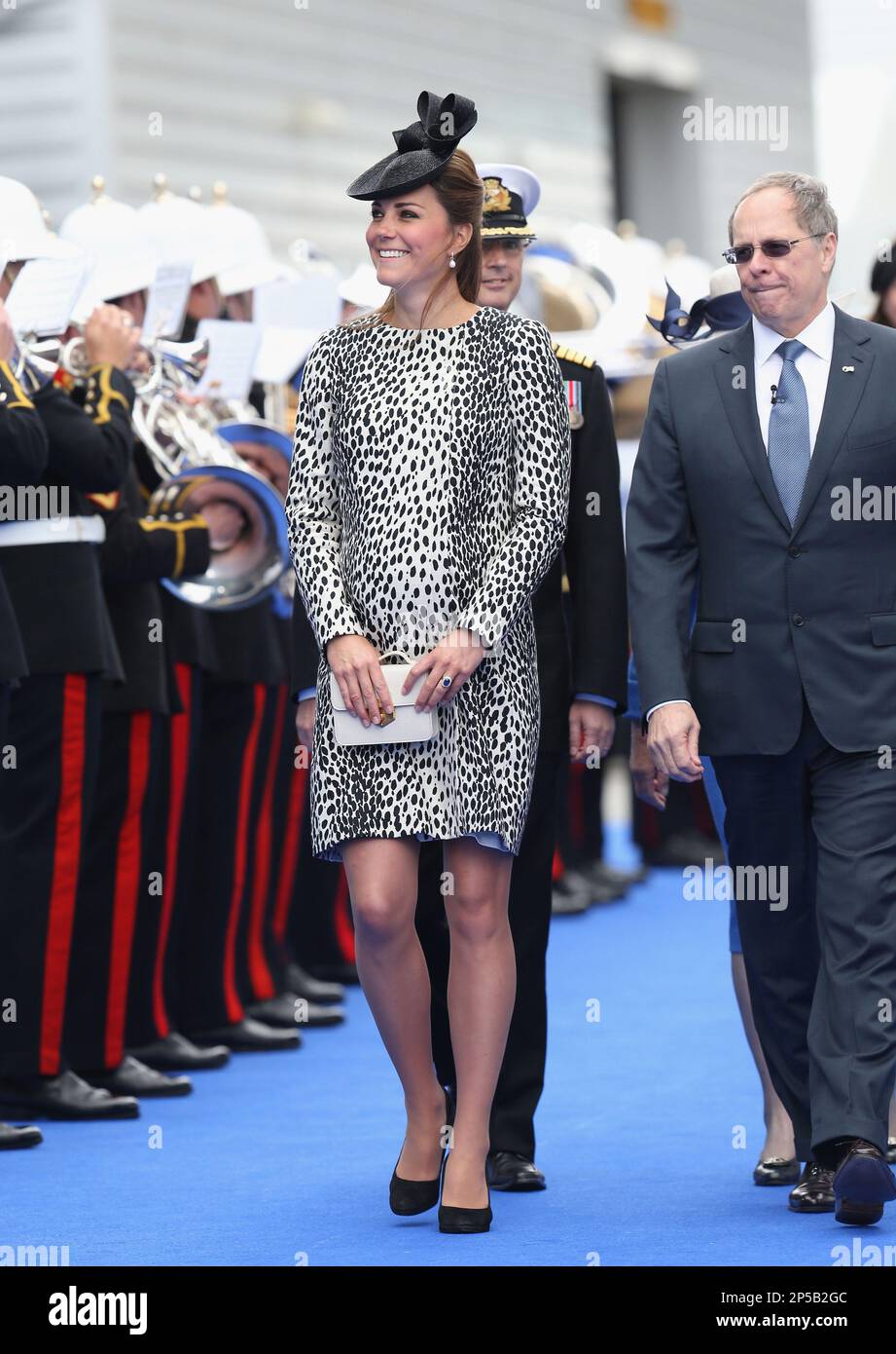 President and CEO of Princess Cruises Alan Buckelew escorts Britain's Duchess of Cambridge during the Princess Cruises ship naming ceremony to officially name the new Royal Princess cruise liner at a gala ceremony, in Southampton, England, Thursday June 13, 2013. It is expected to be her final planned solo event before the birth. (AP Photo/Chris Jackson, Pool) Banque D'Images