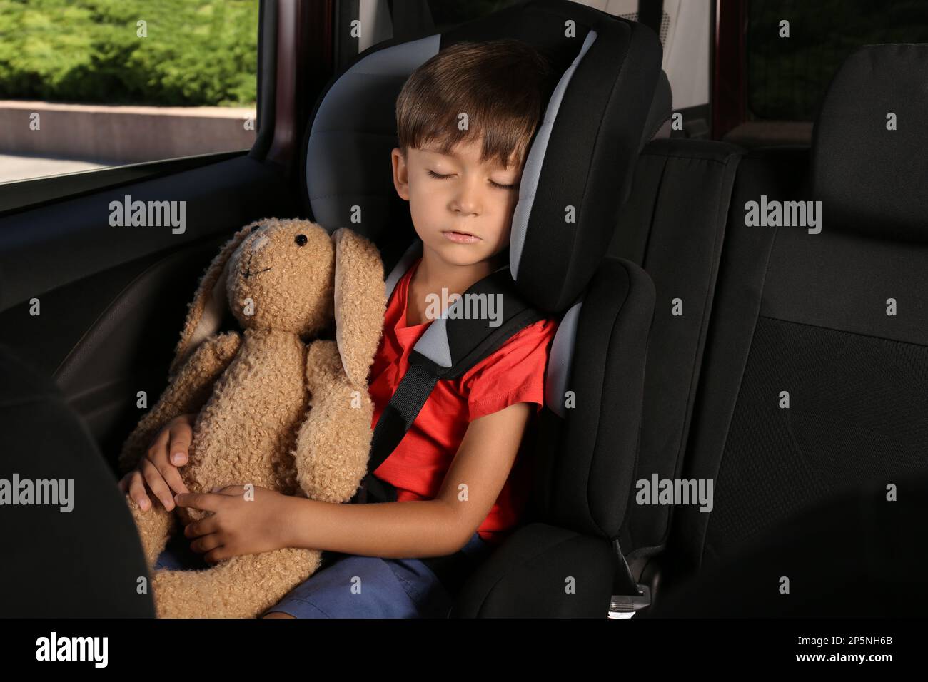 Petit Garçon Attaché Dans Un Siège Auto à L'épreuve Des Enfants à L'arrière  De La Voiture Pour Sa Sécurité Et Sa Protection