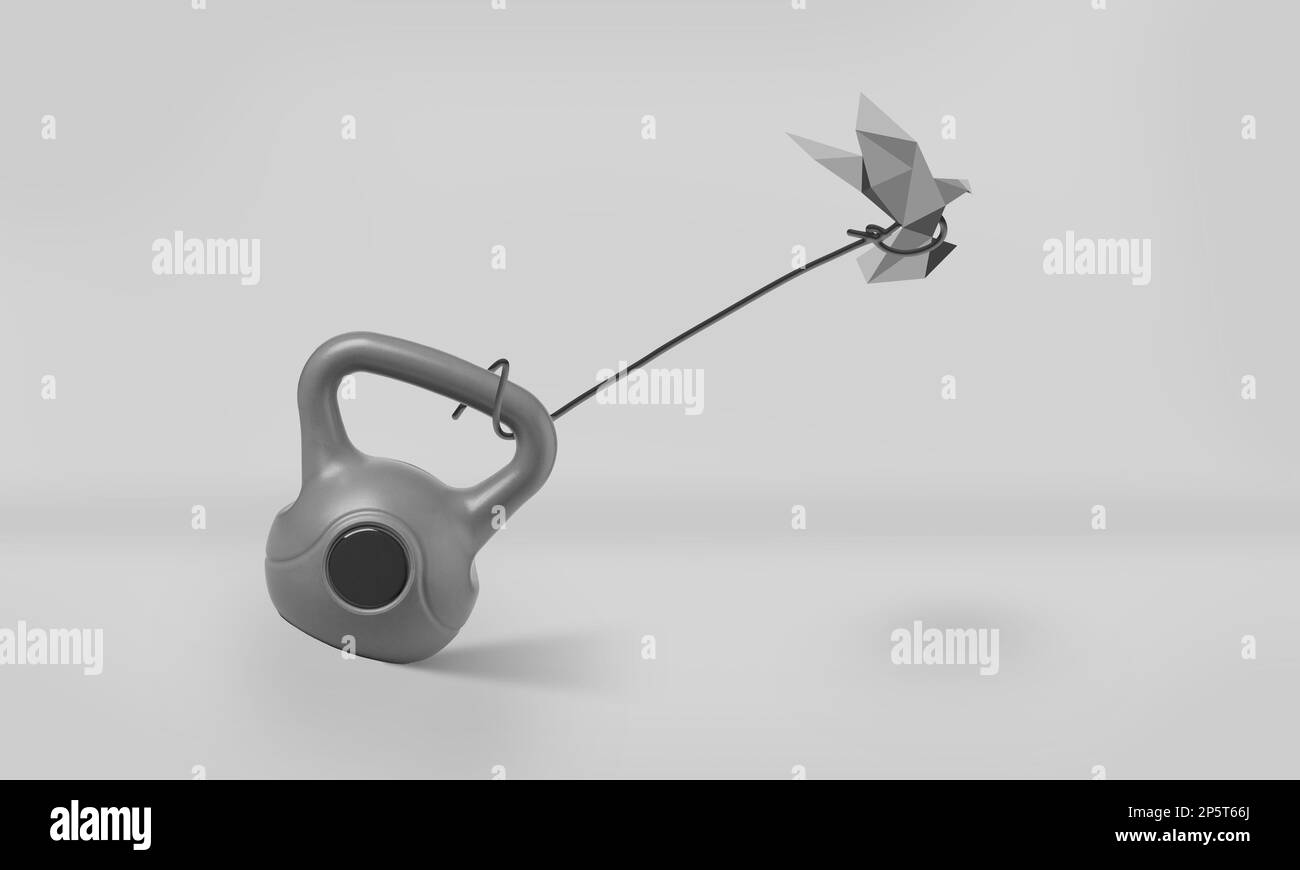 Origami oiseau essayant à peine de voler tout en étant attaché à Un poids lourd de Kettlebell. Concept de restriction, de liberté, de lutte et de défi Banque D'Images