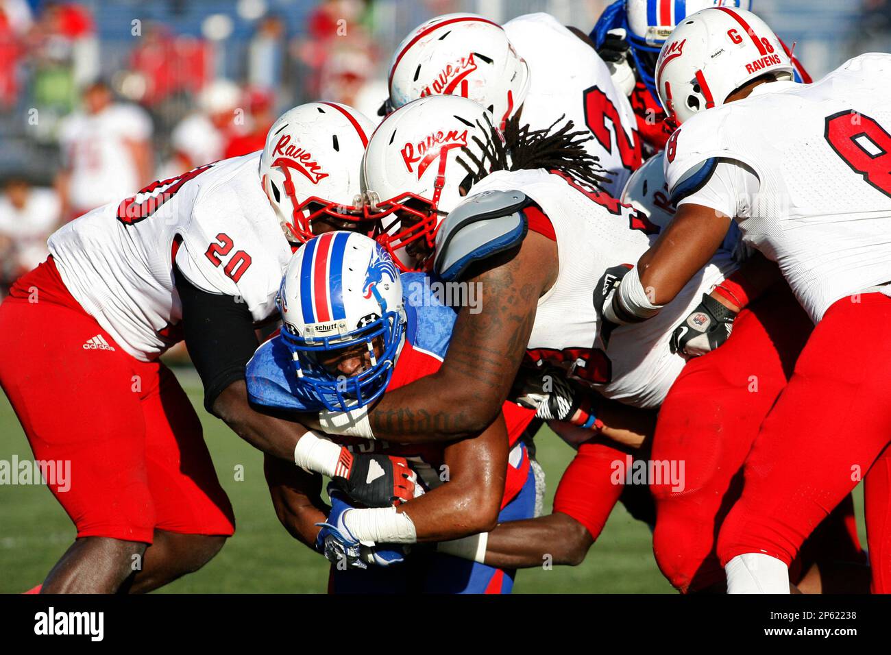 Hutchinson Community College's Orange Mooney (11) is gang tackled by Coffeyville players during the second half of their NJCAA Region VI college playoff semifinal game, Sunday, Nov. 4, 2012, in Hutchinson, Kan. (AP Photo/The Hutchinson News, Lindsey Bauman) Banque D'Images