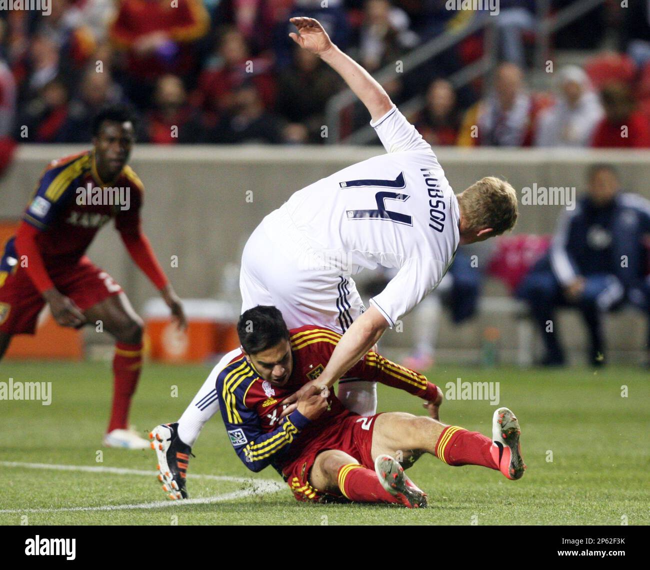Real Salt Lake player David Viana (25) tries to pull Vancouver FC midfielder Barry Robson (14) down to the ground during an MLS soccer match on Saturday, Oct. 27, 2012, at Rio Tinto Stadium in Sandy, Utah. RSL and the Whitecaps played to a 0-0 draw. (AP Photo/The Salt Lake Tribune, Kim Raff ) DESERET NEWS OUT; LOCAL TV OUT; MAGS OUT Banque D'Images