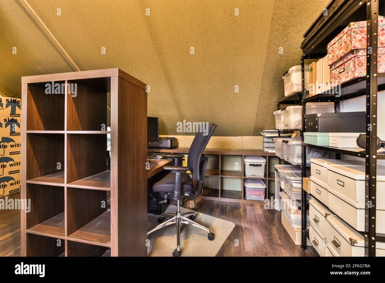 un espace de bureau avec des bureaux et des étagères sur le mur derrière lui, il y a une chaise dans le coin Banque D'Images