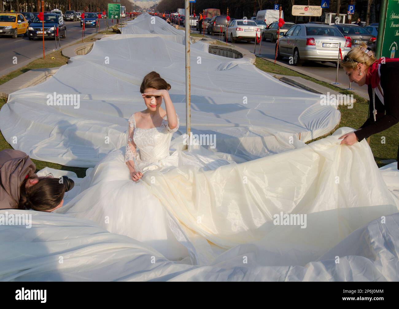 Emma Dumitrescu 17 years old a model poses to show the world s longest wedding dress train during a Guinness World Record attempt in Bucharest Romania Tuesday March 20 1012. Romania has set the