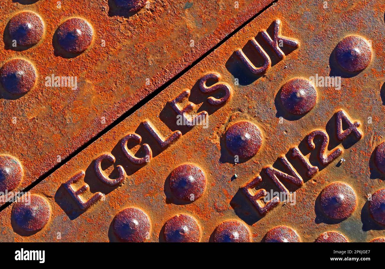 Fonte, Eccles rouillés en relief, couverture de la grille de rue, Manchester / Salford Banque D'Images